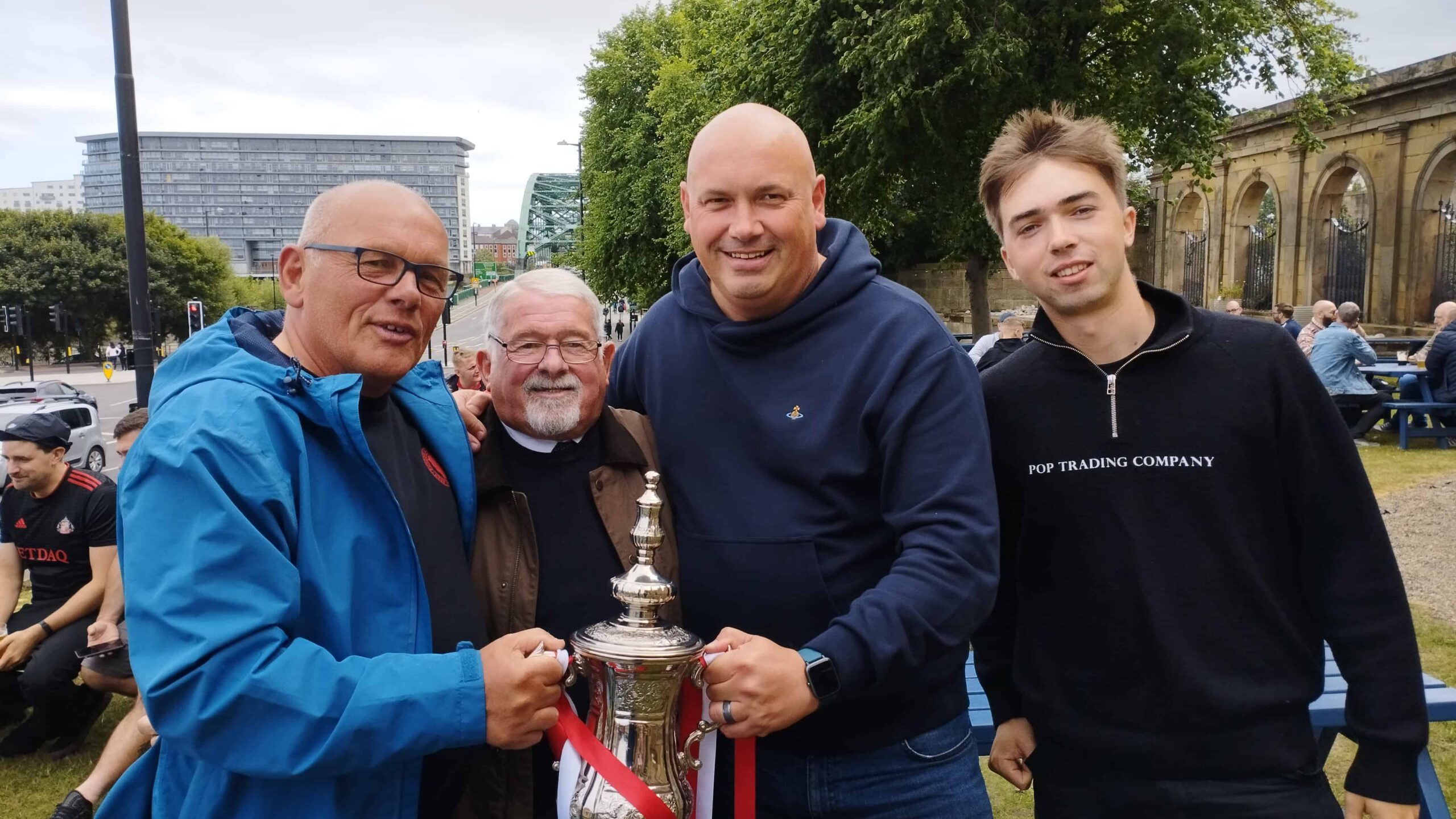fans holding the fa cup outside with 1973 fa cup captain bobby kerr